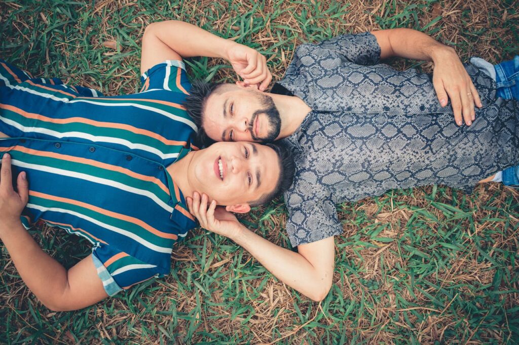 Two Men Lying on Green Grass