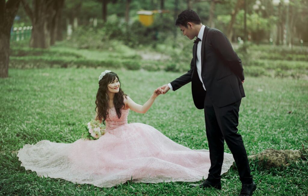 Man in 2-piece Suit Holding Woman in Peach-colored Wedding Gown White Holding Her Flower Bouquethttps://galabuzispells.com/love-spells/